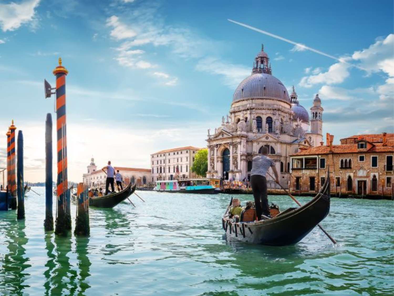 A gondola gliding down a historic canal in Venice, Italy.